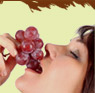 Woman eats grapes